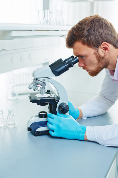 researcher using microscope 