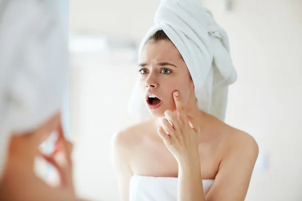 Girl looking at acne — Stock Photo, Image