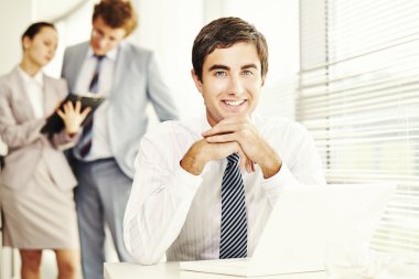 İş adamı iş yerinde oturuyor.