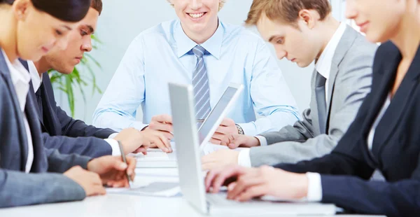 Business people sitting busy at table — Stock Photo, Image