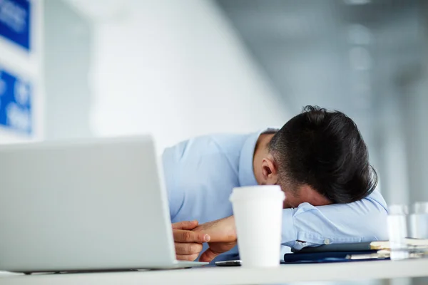 Businessman lying on table — Stock Photo, Image