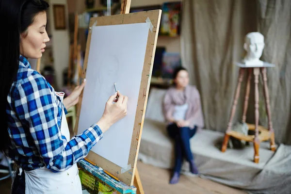 Young student drawing face of girl — Stock Photo, Image