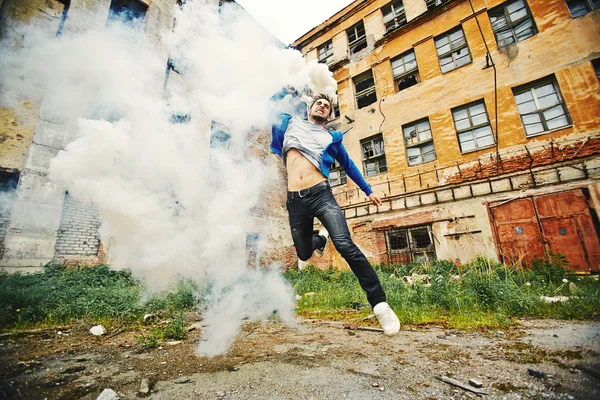 Young man running with smoke — Stock Photo, Image