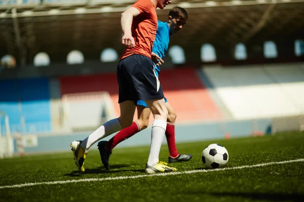 Players following ball — Stock Photo, Image