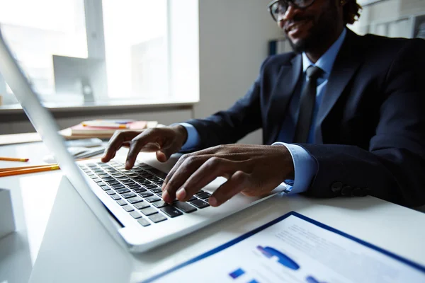 Empleado escribiendo en el ordenador portátil — Foto de Stock