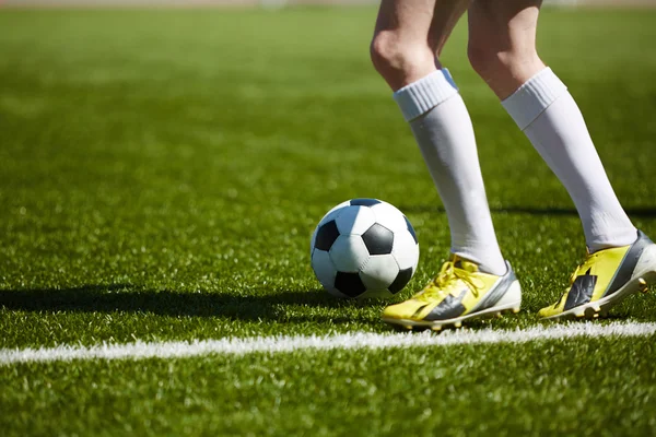 Legs and soccer ball Stock Picture