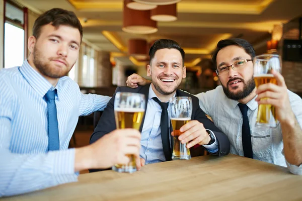 Business men toasting with lager — стоковое фото