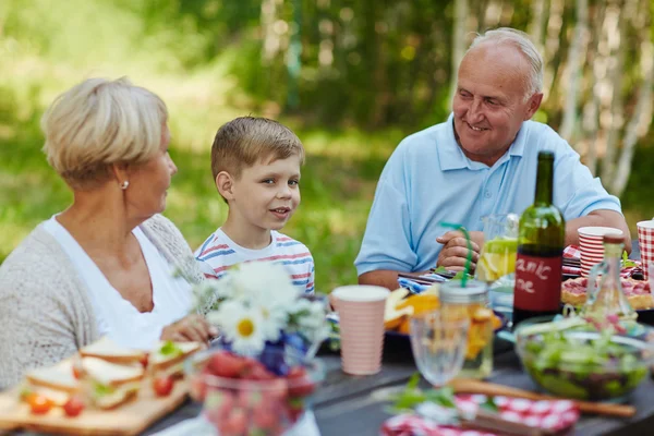 Großeltern und Junge essen zu Abend — Stockfoto