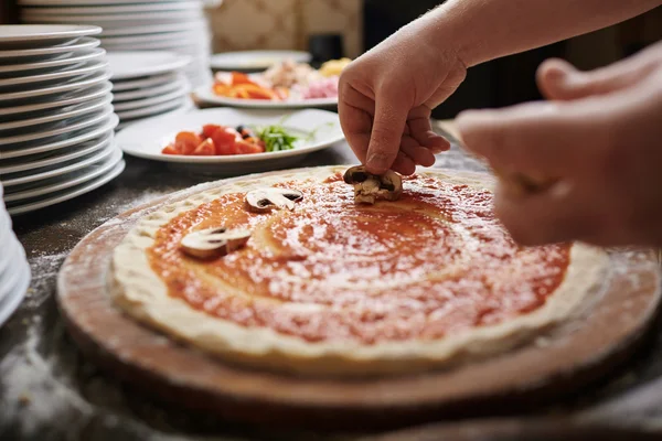 Kuchař vaření pizza s houbami — Stock fotografie