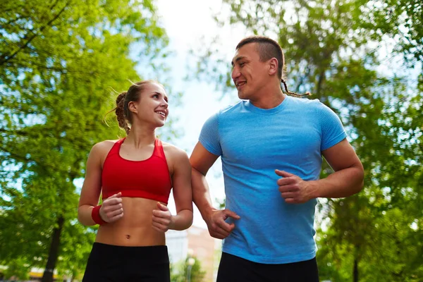 Happy young couple running — Stock Photo, Image