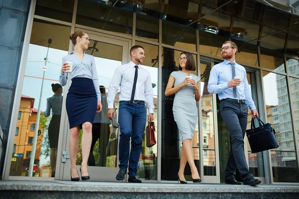 Group of co-workers leaving office center — Stock Photo, Image