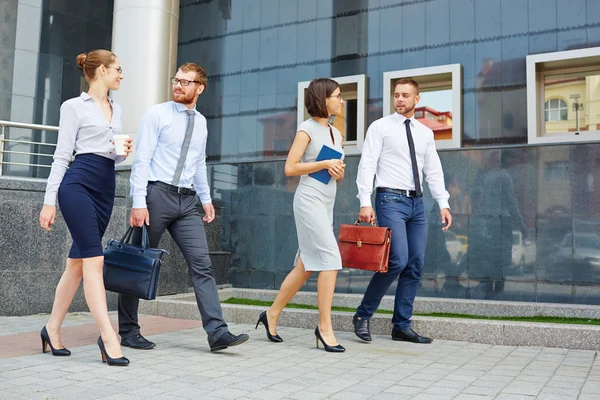 White collar workers talking while going — Stock Photo, Image