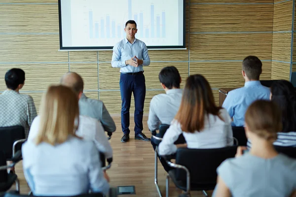 Businessman reading lecture in conference hall — Stock Photo, Image