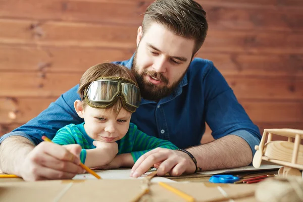 Mann mit Sohn zeichnet Skizze von Spielzeug — Stockfoto