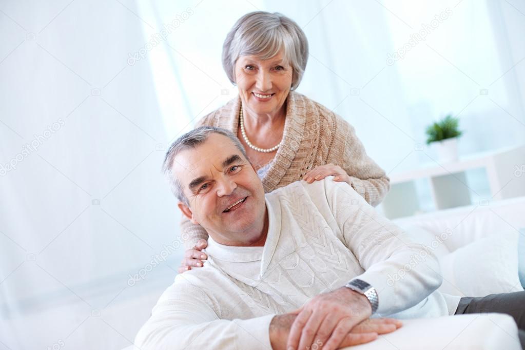 Happy senior couple looking at camera 