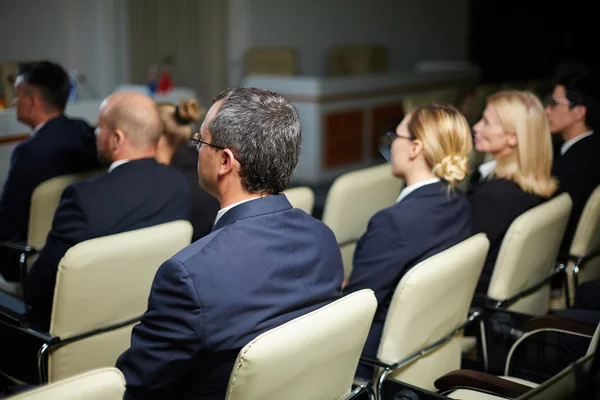 Business people listening to deputy speech — Stock Photo, Image
