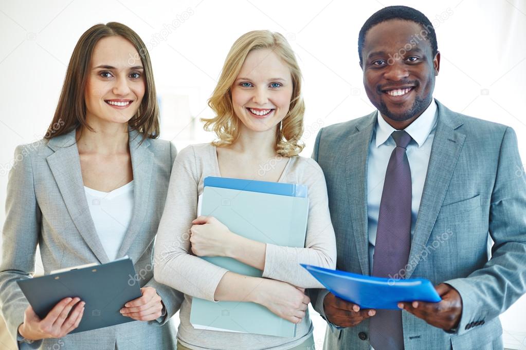 Successful businesspeople smiling to camera 