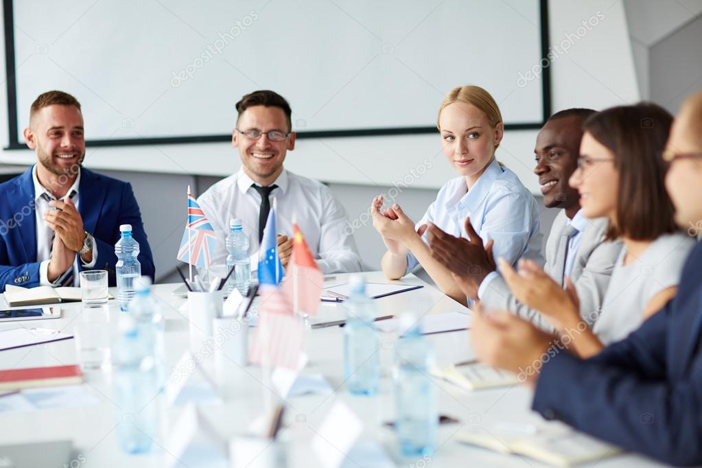 Successful professionals applauding after speech