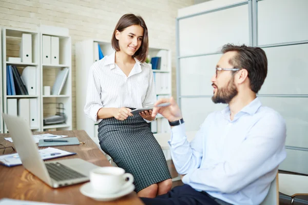 Businesswoman  looking at co-worker at meeting — Stock Photo, Image