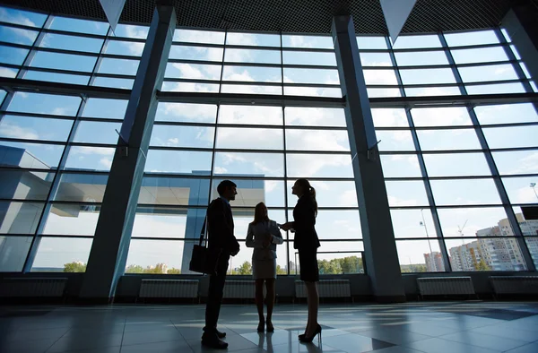 Businesspeople standing in business center and talking — Stock Photo, Image