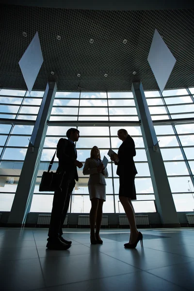 Colleagues interacting in business center — Stock Photo, Image