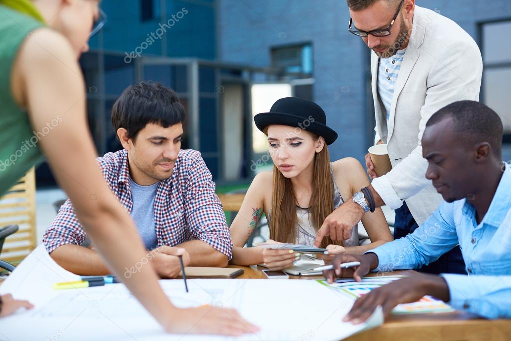 Designers discussing sketch of future building