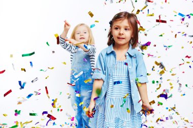 Lttle girls playing with confetti clipart