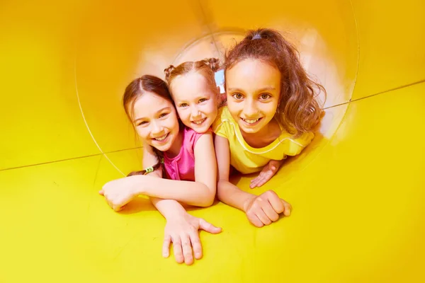 Three girls having fun on slide — Stock Photo, Image