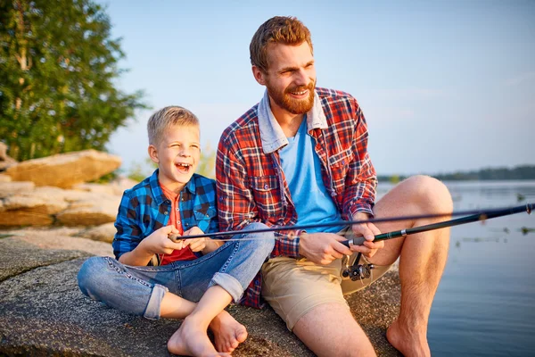 Young man and little boy fishing — Stock Photo, Image