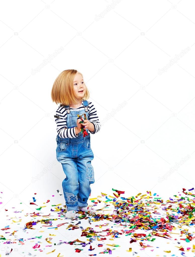 Cute girl playing with confetti 