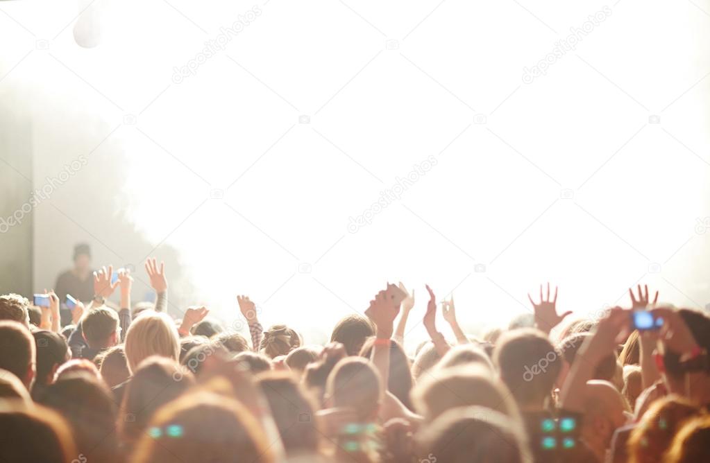 People in front of bright stage