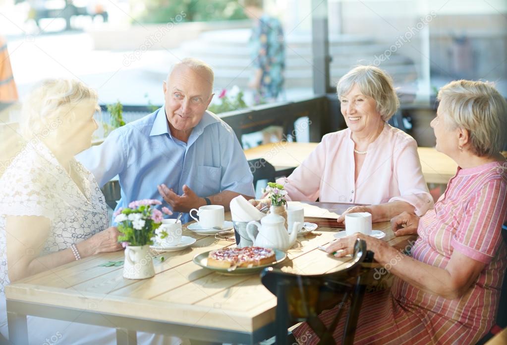 Seniors talking in cafe