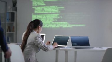 Orta yaşlı bilgisayar programcısı kız arkadaşıyla buluşup bilgisayar başında şifreli bir şekilde modern donanımlı sınıfta otururken.