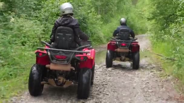 Seguimiento Toma Personas Cascos Que Viajan Quads Través Charcos Largo — Vídeo de stock