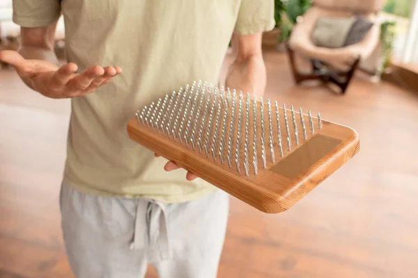 Young Male Yoga Instructor Holding Wooden Pad Nails While Presenting — Stock Photo, Image