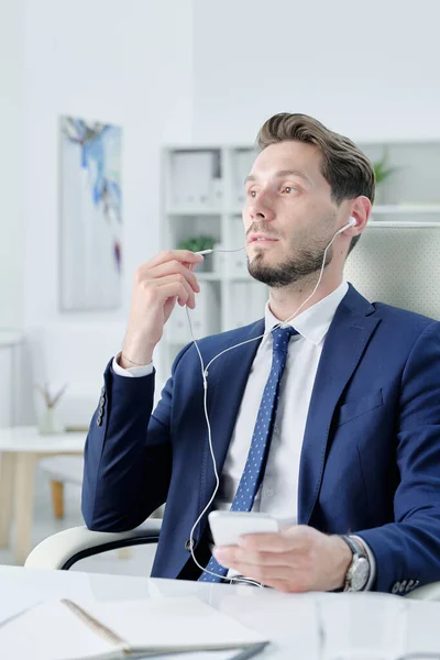 Smiling Dreamy Young Businessman Enjoying Music Earphones While Thinking New — Stock Photo, Image