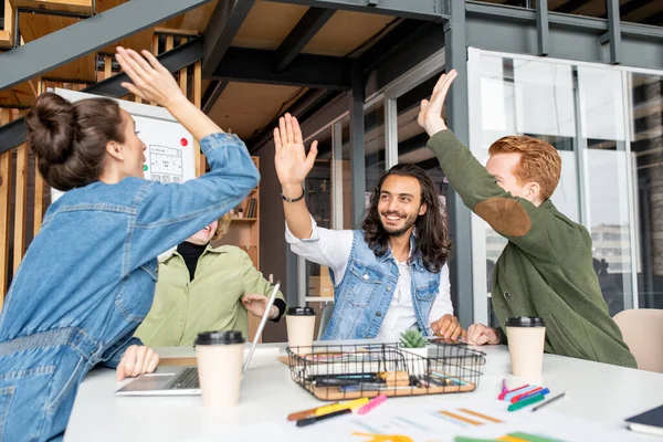 Four Young Joyful Successful Colleagues Giving Each Other High Five — Stock Photo, Image