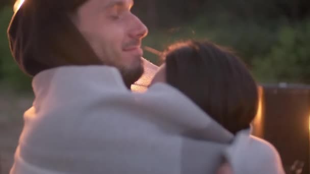一对快乐的年轻夫妇在露天派对上用毛毯热身 而男人则在额头上浪漫地吻着女友 — 图库视频影像