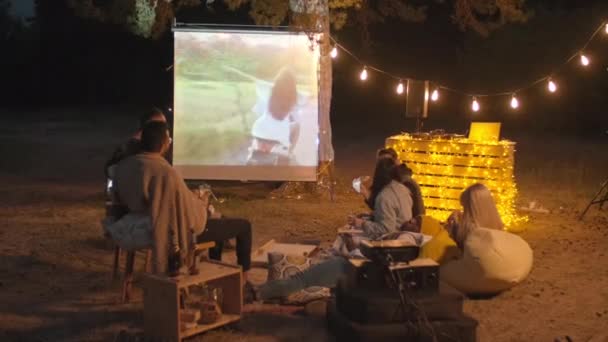 朋友们一起在电影院看电影 一边吃披萨 一边喝啤酒 — 图库视频影像