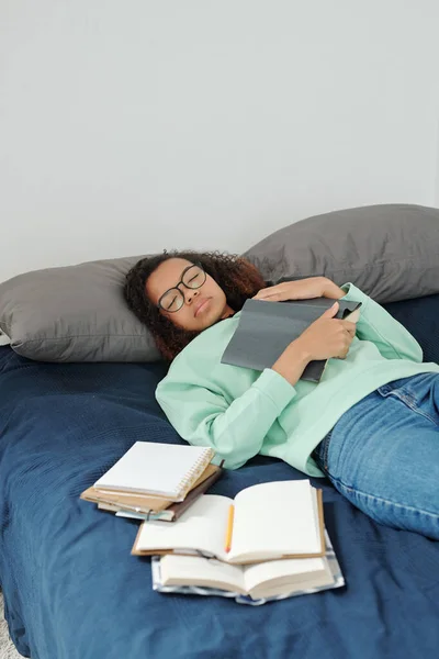Young Tired Student Keeping Open Book Chest While Lying Bed — Stock Photo, Image