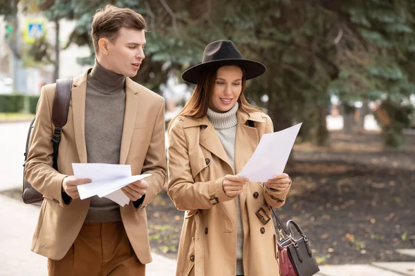 Two Young Colleagues Elegant Casualwear Reading Papers Discussing Them While — Stock Photo, Image