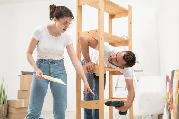 Frowning Puzzled Young Woman Looking Assembly Plan Confusion While Her — Stock Photo, Image