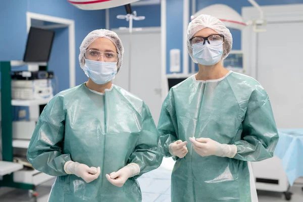 Dos Jóvenes Cirujanas Profesionales Uniforme Protector Guantes Máscara Anteojos Monos — Foto de Stock