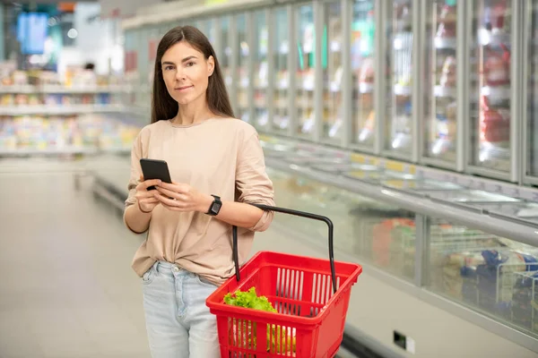 Horizontal Medium Long Portrait Young Adult Woman Standing Aisle Holding — Stock Photo, Image