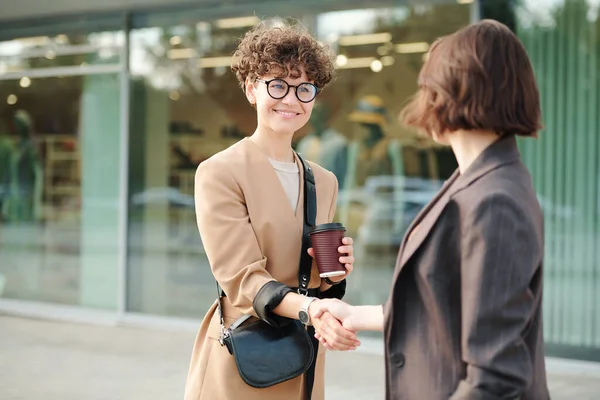 Two Young Female Colleagues Business Partners Shaking Hands Negotiating While — Stock Photo, Image