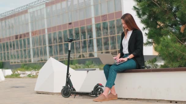 Kompletní Záběr Mladé Ženy Sedí Lavičce Pracuje Notebooku Scooter Blízkosti — Stock video