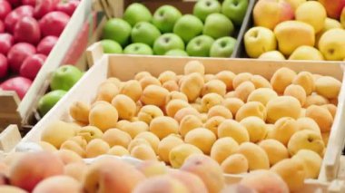 Markette meyve tezgahında duran olgun kayısıların, nektarinlerin ve elmaların izini sürüyorum.