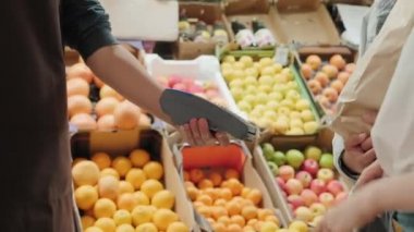 Marketteki alışverişi ödemek için cep telefonu kullanan tanınmayan bir çiftin el kamerası görüntüsü.