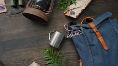 Üzerinde seyahat aksesuarları bulunan biletlerle pasaportları tahta masaya koyan tanınmamış genç bir kadının ilk görüntüsü.