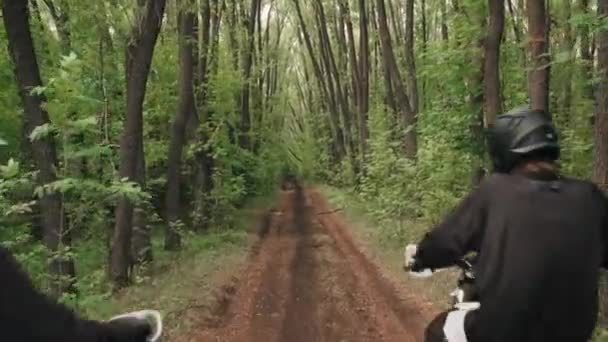 Tracking Shot Men Gear Helmets Riding Motorcycles Dirt Road Forest — Stock Video